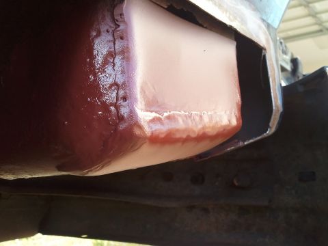 1989 Ford Bronco - Frame repair work in progress on a vehicle, showing primer and filler application.
