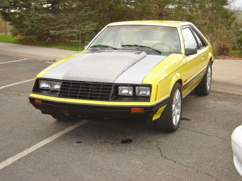 1979 Ford Mustang - Front 3/4 view of a yellow 1979 Ford Mustang hatchback with a grey hood.
