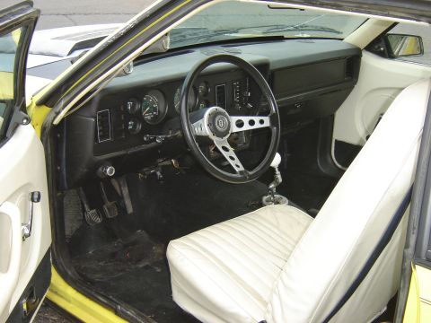 1979 Ford Mustang - Interior view of a 1979 Ford Mustang, white seats and a custom steering wheel.