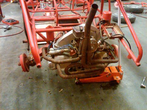 1995 Ford F-150 - The engine and frame of a custom vehicle project are visible in this workshop photo.