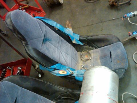 1995 Ford F-150 - These blue bucket seats with DEIST racing harnesses appear to be part of a project in a workshop setting.