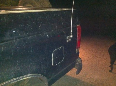 1990 Ford Bronco - Rear view of a black SUV, showing the quarter panel, antenna, and taillight.