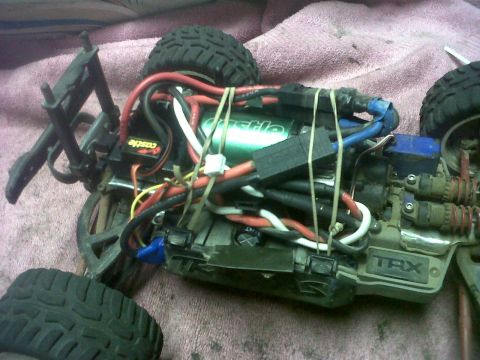2011 Ford 427 - Close-up of an RC car's internal components, including motor, wiring, and suspension parts.