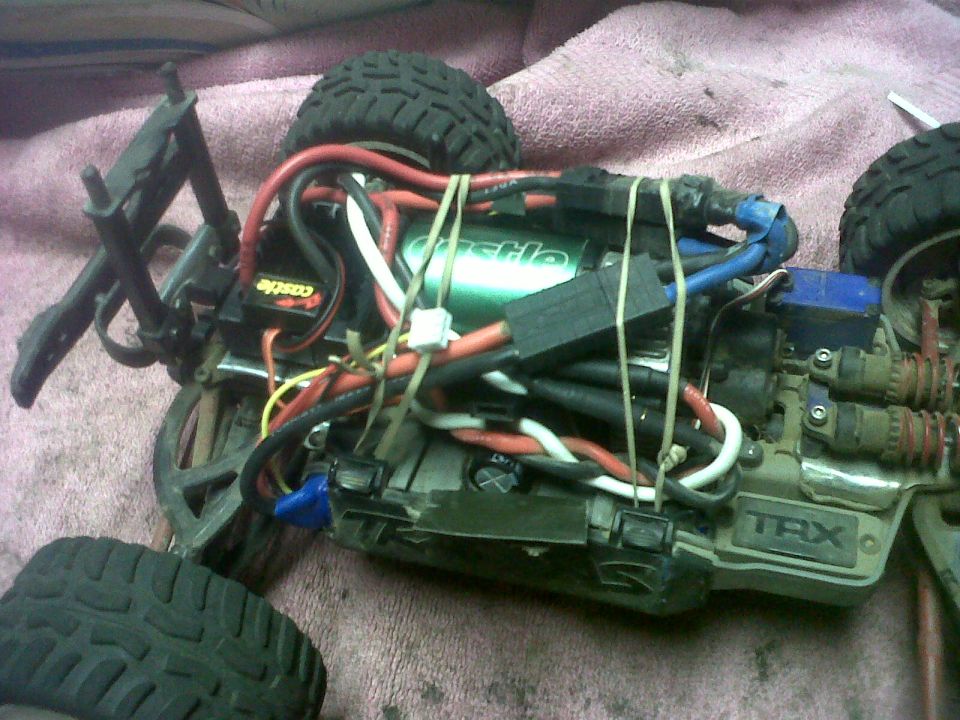 RC car chassis with a green motor, lots of wires, and 'TRX' logo