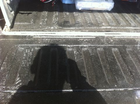 1990 Ford Bronco - The bedliner of a truck shows some white residue and tire marks.
