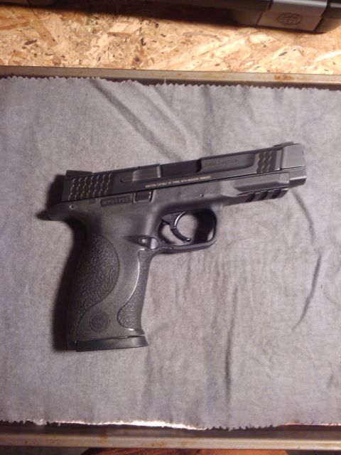 1989 Ford Bronco - Semi-automatic pistol shown from the side, with visible text on the slide.