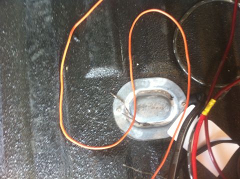 1990 Ford Bronco - Close-up of wiring and a grommet in a textured truck bed.
