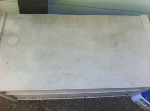1990 Ford Bronco - A weathered plastic storage container sits outdoors, showing signs of use.