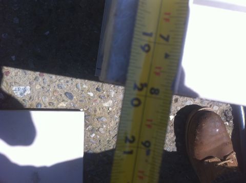 1990 Ford Bronco - Measuring tape on concrete surface with a white object in the foreground.