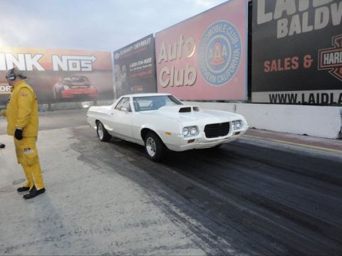 1972 Ford Ranchero - White 1972 Ford Ranchero on drag strip with driver in yellow suit.