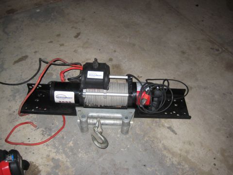 2005 Jeep Wrangler - A close-up view of an Industrial 9000 winch, showing its cable and hook assembly.