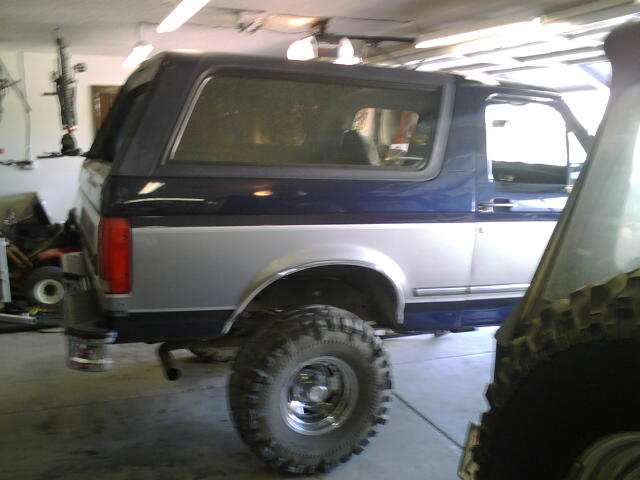 Side view of a 1995 Ford Bronco with blue and silver paint