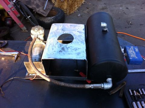 2003 Ford F-250 - Custom air compressor and tank assembly with metal housing and hoses.