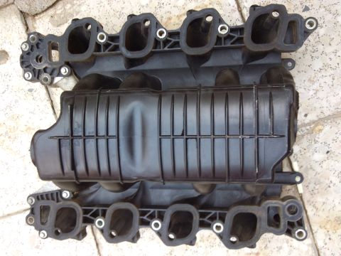 1998 Ford Crown Victoria - A black plastic intake manifold is shown from above, with visible ports and a watermark at the bottom right.