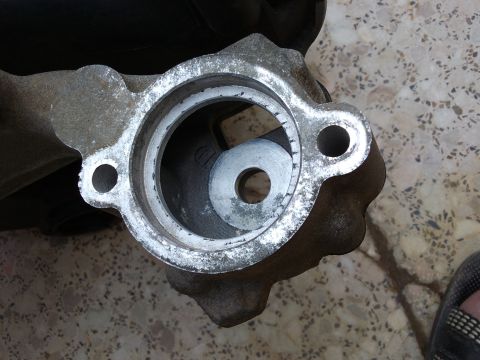 1998 Ford Crown Victoria - This is a close-up view of a metal automotive component, likely a housing or bracket.