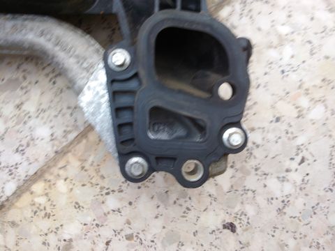 1998 Ford Crown Victoria - A close-up view of an automotive intake manifold gasket and part of the pipe it attaches to.