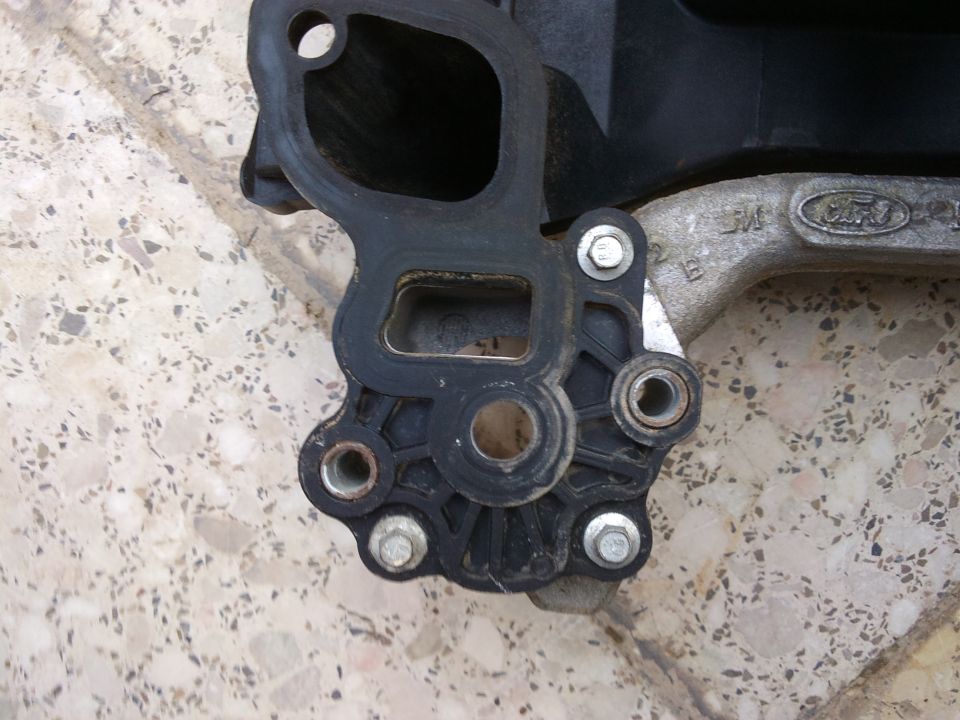 Ford intake manifold part with visible Ford logo