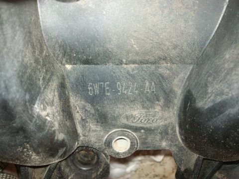 1998 Ford Crown Victoria - Close-up of a Ford intake manifold part, showing the part number 6W7E-9424-AA and the Ford logo.