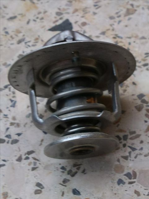 1998 Ford Crown Victoria - A car thermostat, a crucial engine component, is shown in detail.