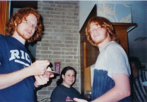 1996 Ford Taurus - A group of people are seen indoors, with one individual holding a small plate with a piece of cake.