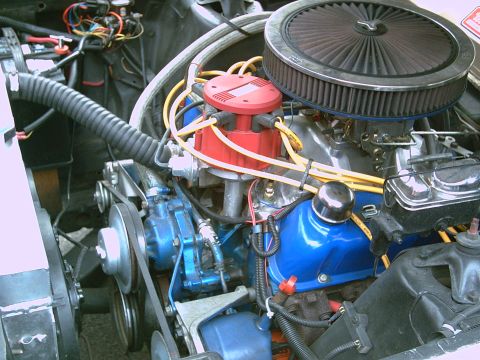 1969 Ford Ranchero - The engine bay features a V8 engine with blue valve covers and a red distributor cap, along with an aftermarket air filter.
