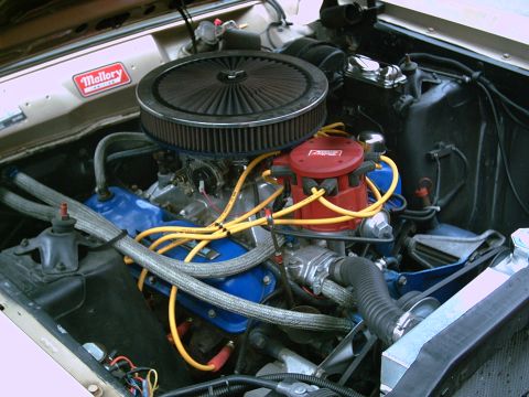 1969 Ford Ranchero - Close-up of a V8 engine bay a Mallory ignition system and a SuperMotors watermark.