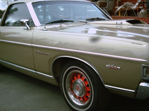 1969 Ford Ranchero - A close-up of a 1969 Ford Ranchero shows its distinctive body lines and a '351' emblem.