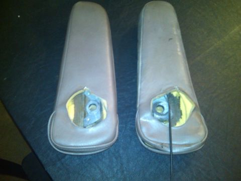 1993 Ford Bronco - Two brown car armrests are shown, with their mounting hardware exposed.