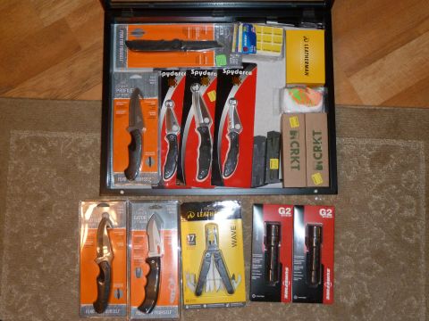 1992 Ford Mustang - A collection of knives, a Leatherman multi-tool, and SureFire flashlights are displayed in their original packaging.