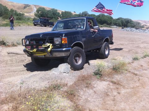 1990 Ford Bronco - This 1990 Ford Bronco is equipped with an aftermarket bumper and flags, seen off-road.