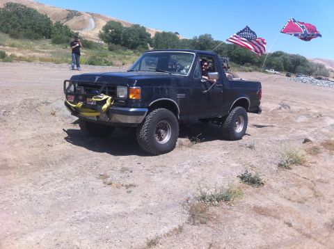 1990 Ford Bronco - This 1990 Ford Bronco is seen off-road with two flags flying from the rear.