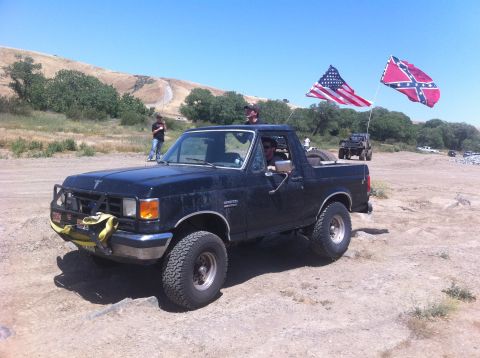 1990 Ford Bronco - This 1990 Ford Bronco is seen with American and Confederate flags flying from its rear.