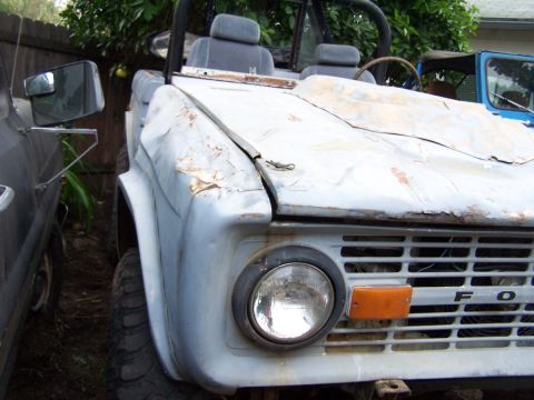1973 Ford Bronco - This Ford Bronco appears to be in rough condition, with visible rust and damage to the hood.