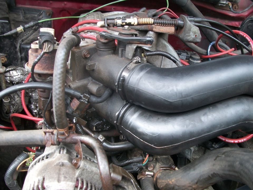 close-up of engine bay with hoses and wires