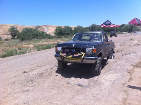 1990 Ford Bronco - This 1990 Ford Bronco is seen off-roading with American and Confederate flags flying.