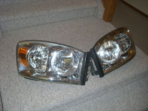 2005 Dodge 3500 - A pair of headlights, likely for a Dodge truck, are displayed on a carpeted staircase.