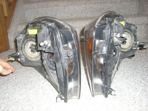 2005 Dodge 3500 - Two vehicle headlights are shown from the rear, resting on a carpeted surface.