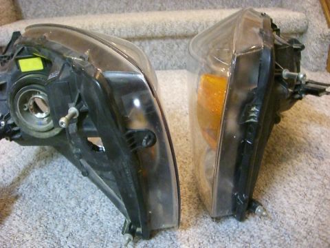 2005 Dodge 3500 - Two vehicle headlights are shown from the side, resting on a carpeted surface.