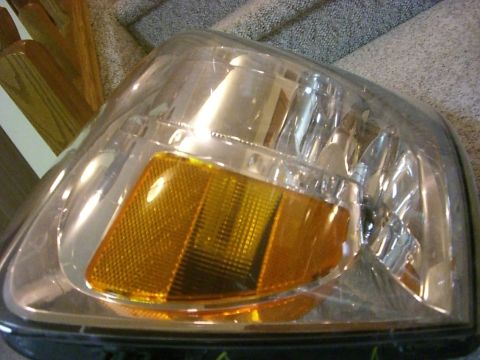 2005 Dodge 3500 - This is a close-up view of a vehicle's headlight assembly, a clear lens and an amber signal light.