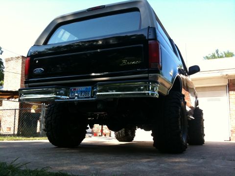 1996 Ford Bronco - This 1996 Ford Bronco is shown from the rear, a lifted suspension and large off-road tires.