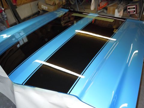 1972 Chevrolet Camaro - A car hood is shown with a blue finish and black and light blue racing stripes.