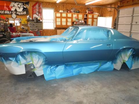 1972 Chevrolet Camaro - A blue Chevrolet Camaro is being prepped for paint in a garage, with plastic sheeting covering most of its body.