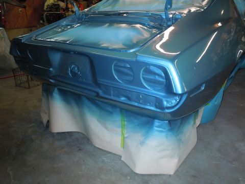 1972 Chevrolet Camaro - The rear of a 1972 Chevrolet Camaro is shown during a paint job, supported by stands and covered in protective paper.