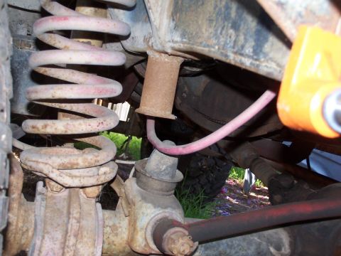 1973 Ford Bronco - Undercarriage view of a vehicle's suspension system, showing aged metal components.