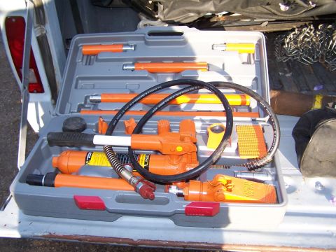 1973 Ford Bronco - Hydraulic porta-power kit with various attachments and hoses, stored in a gray case.
