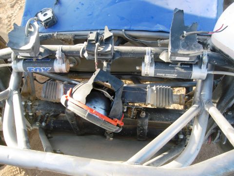1986 Ford Bronco - Close-up view of the front suspension and steering system of a custom off-road vehicle.