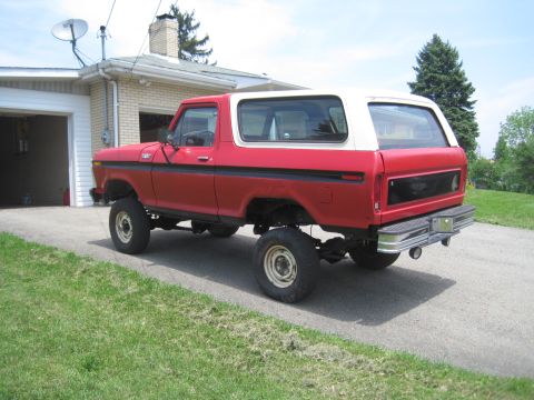 1979 Ford Bronco - This SUV has a two-tone paint scheme with a red body and a white hardtop.