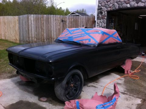 2001 Ford F-350 - A black convertible is being prepped for painting, with masking tape covering the top and pink paper protecting the wheels.