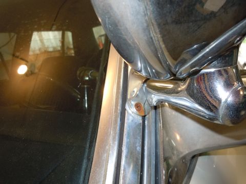 2001 Ford Crown Victoria - Close-up view of the chrome side mirror and window trim, showing mounting hardware.