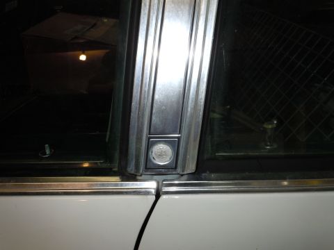2001 Ford Crown Victoria - Detail shot of a car's door trim and window hardware.